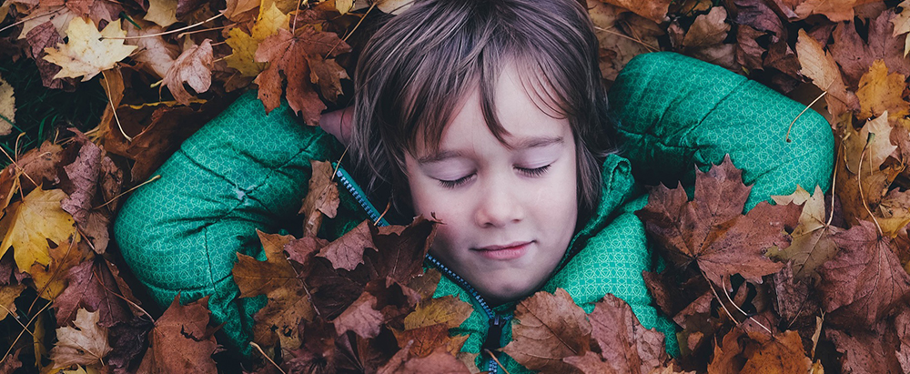 child in leaves 