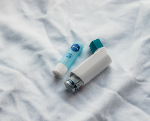 Chapstick next to an inhaler