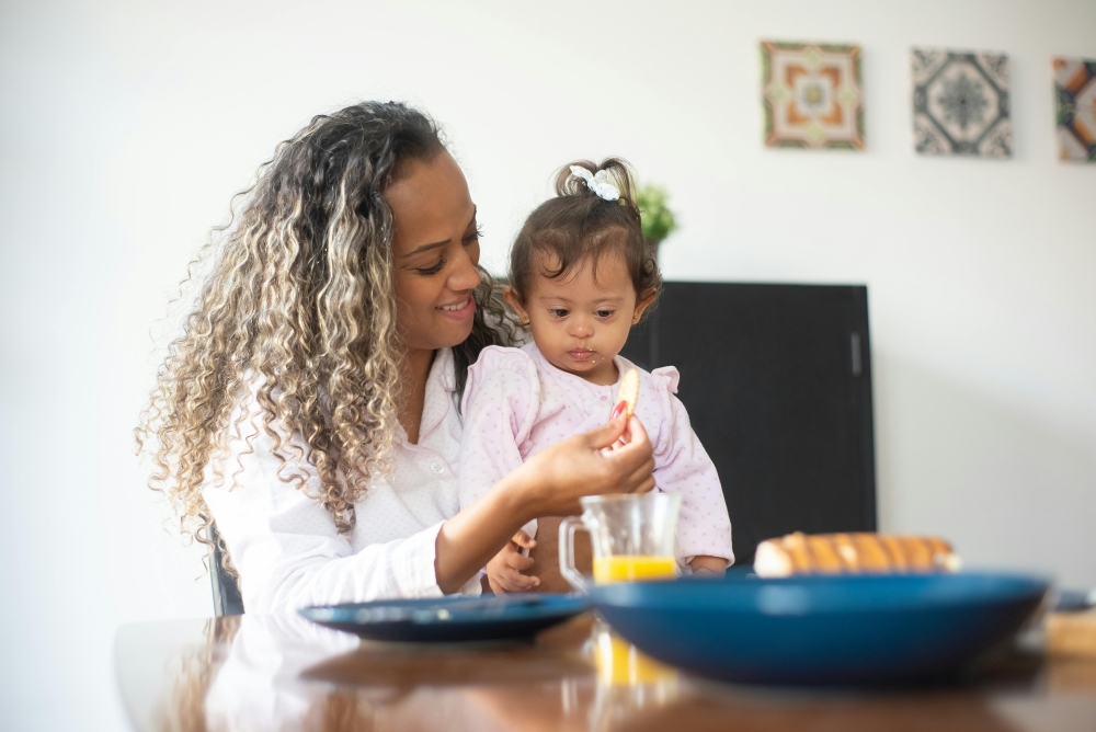 Mother feeding young child