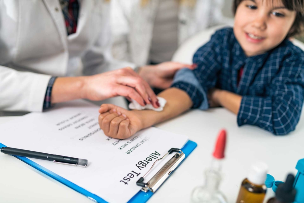 doctor holding a bandage on a child after receiving a shot