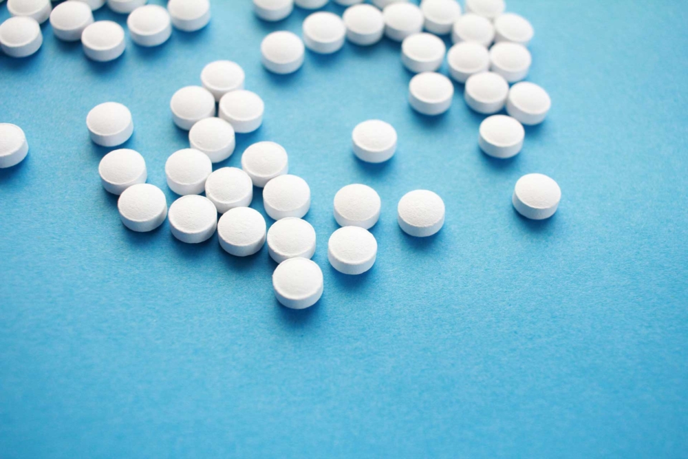 white-medication-on-blue-background